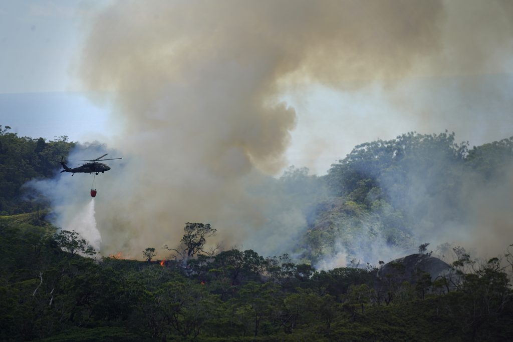 A military helicopter drops water on a large vegetation fire in the Mililani Mauka-Launani Valley area Monday, Oct. 30, 2023, as seen from the Ewa Forest Reserve. (Kevin Fujii/Civil Beat/2023)