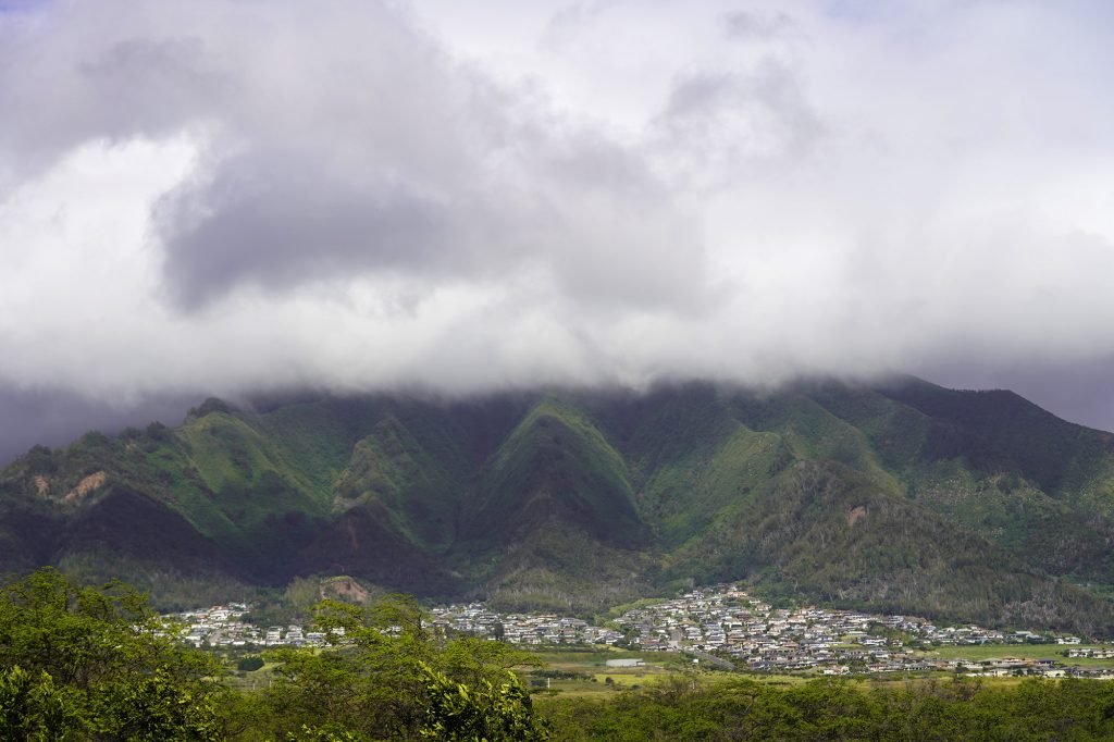 Clouds obscure Kapilau Ridge, Puu Lio and Puukukui mountains above homes in the Upper Wailuku neighborhood are photographed Tuesday, April 2, 2024, from Kahului. (Kevin Fujii/Civil Beat/2024)