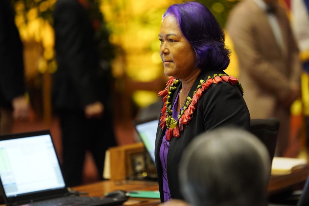 Rep. Elle Cochran walks the House of Representatives floor before passing the state budget HB1800 HD1 Wednesday, March 13, 2024, in Honolulu. The House of Representatives voted to pass its third reading to cross over to the senate. (Kevin Fujii/Civil Beat/2024)