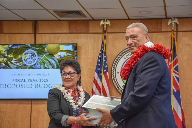 Maui County Mayor Richard Bissen delivers his proposed FY2025 budget of nearly $1.7 billion on Monday to County Council Chair Alice Lee. (Cammy Clark/Civil Beat/2024)