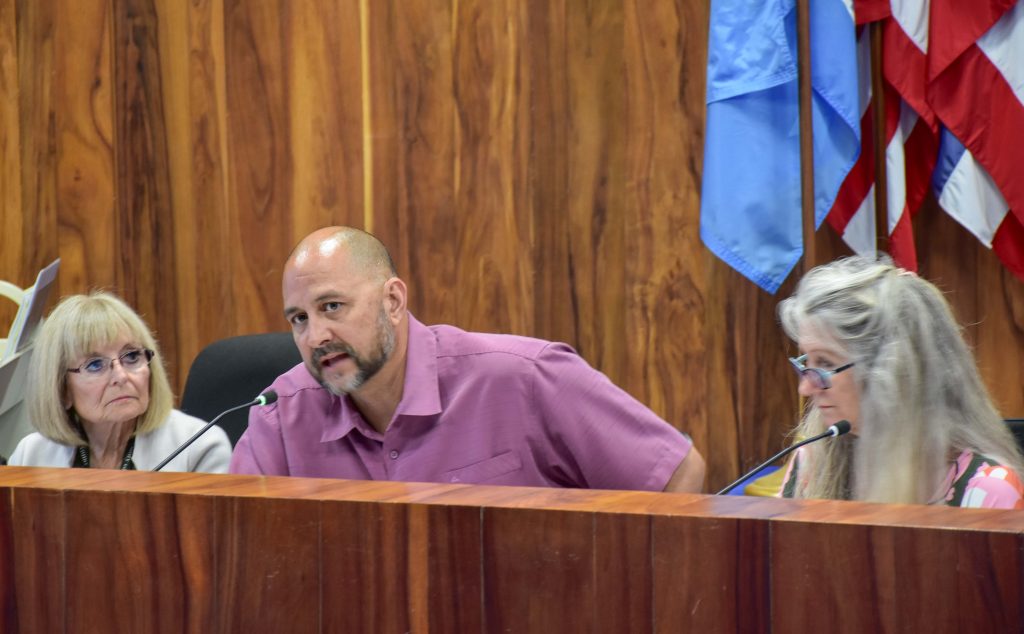 The Department of Finance's Maria Zielinsk (interim director), Steve Tesoro (deputy director) and Marcy Martin (real property tax administrator) discuss the proposed budget at a County Council Meeting on April 1, 2024. (Cammy Clark/Civil Beat/2024)