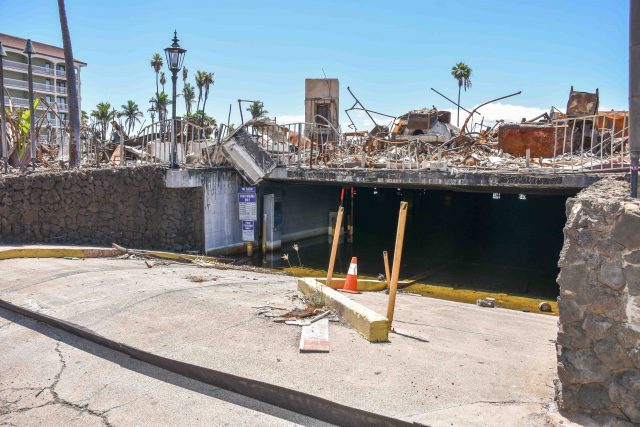 One of the trickiest commercial buildings to clear of fire debris is 505 Front St., which includes a flooded underground garage and is next to a surviving building, Lahaina Shores Beach Resort. (Cammy Clark/Civil Beat/2024)