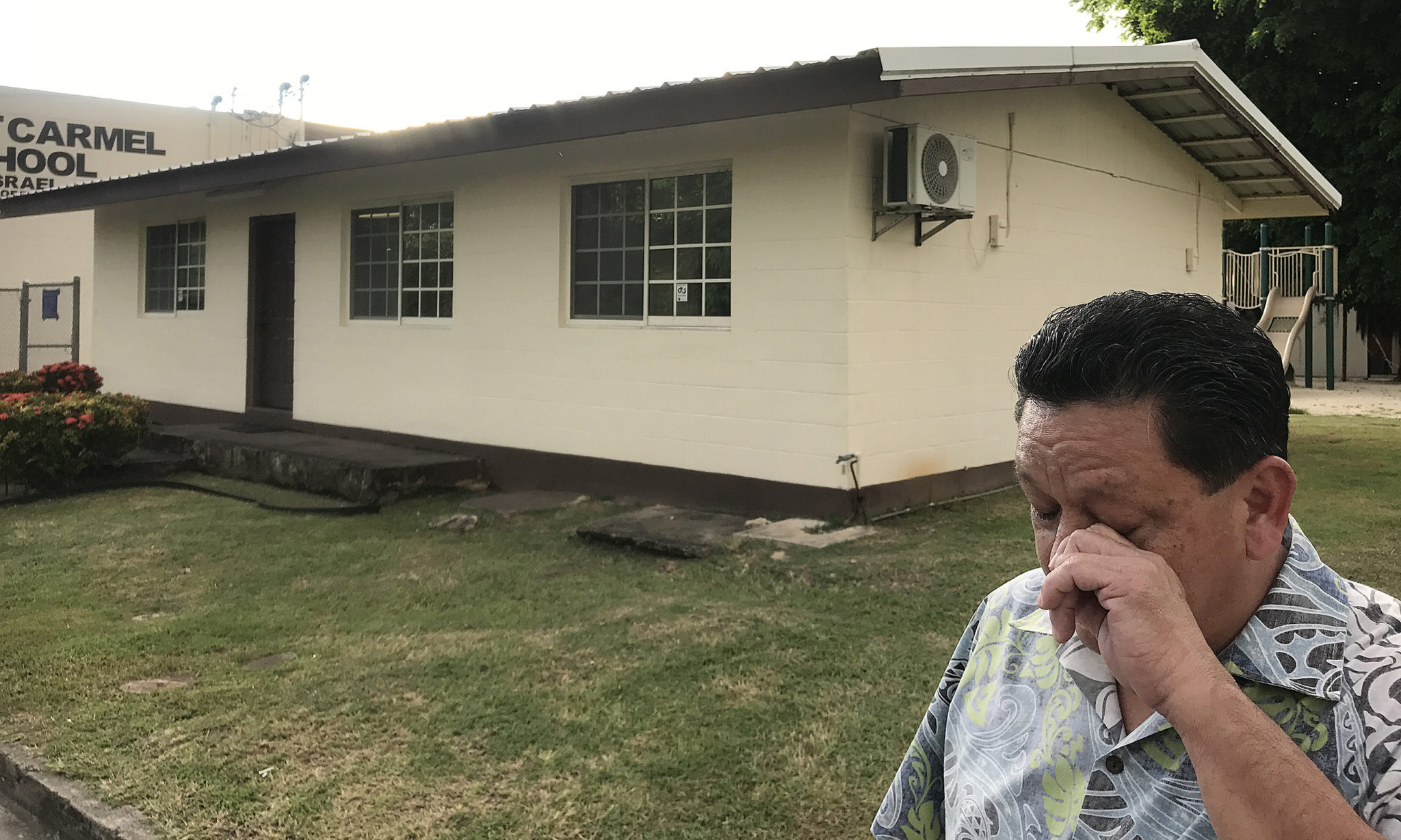 Former Agat, Guam altar boy Roland Paul L Sondia wipes away tears while standing near Father Apuron’s priest quarters in Agat, Guam. Sondia was about 12-years when he alleged he was invited into now Archbishop Apuron’s room in the evening and sexually abused.