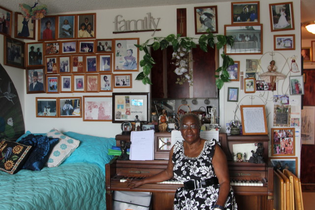 Nellie Miller sits at her piano in her one-bedroom unit at Pearlridge Gardens & Tower across from the mall. She is frustrated by rising maintenance fees that make it difficult for her to afford food and medicine. 