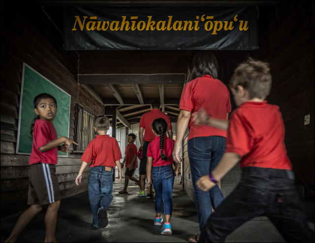 Students walk into Nawahiokalani'opu'u Hawaiian Immersion School in Keaau, Hawaii.