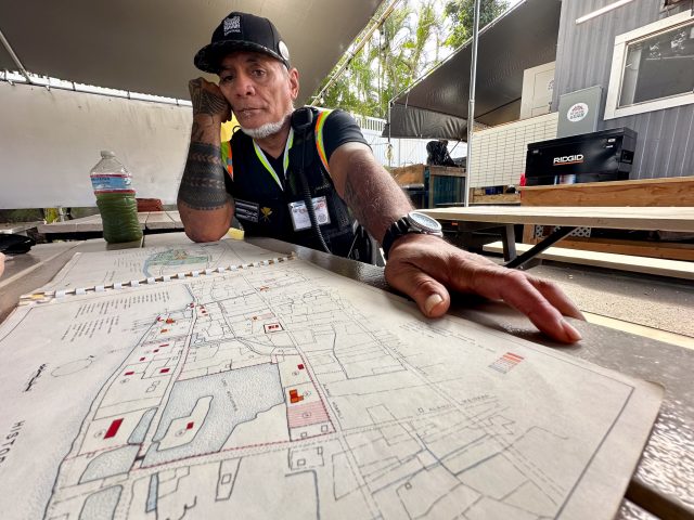 Keeaumoku Kapu looks over an old map of Lahaina, March 12, 2024. (Nathan Eagle/Civil Beat/2024)