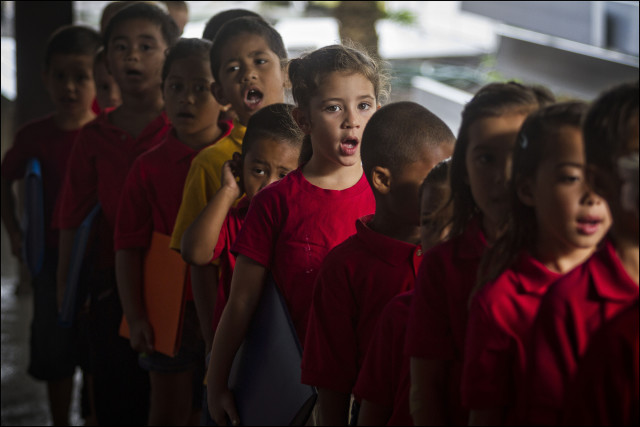Students sing during start of day protocol at the  Nawahiokalani'opu'u Hawaiian Immersion School in Keaau, Hawaii.