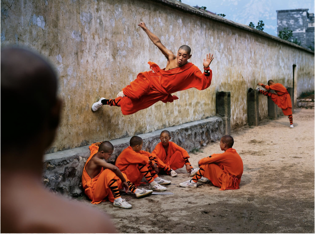 Monk running on a wall at Shaolin Monastery, Hunan Province, China.